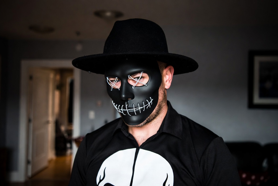Man in black skull mask and fedora Man in black skull mask and fedora