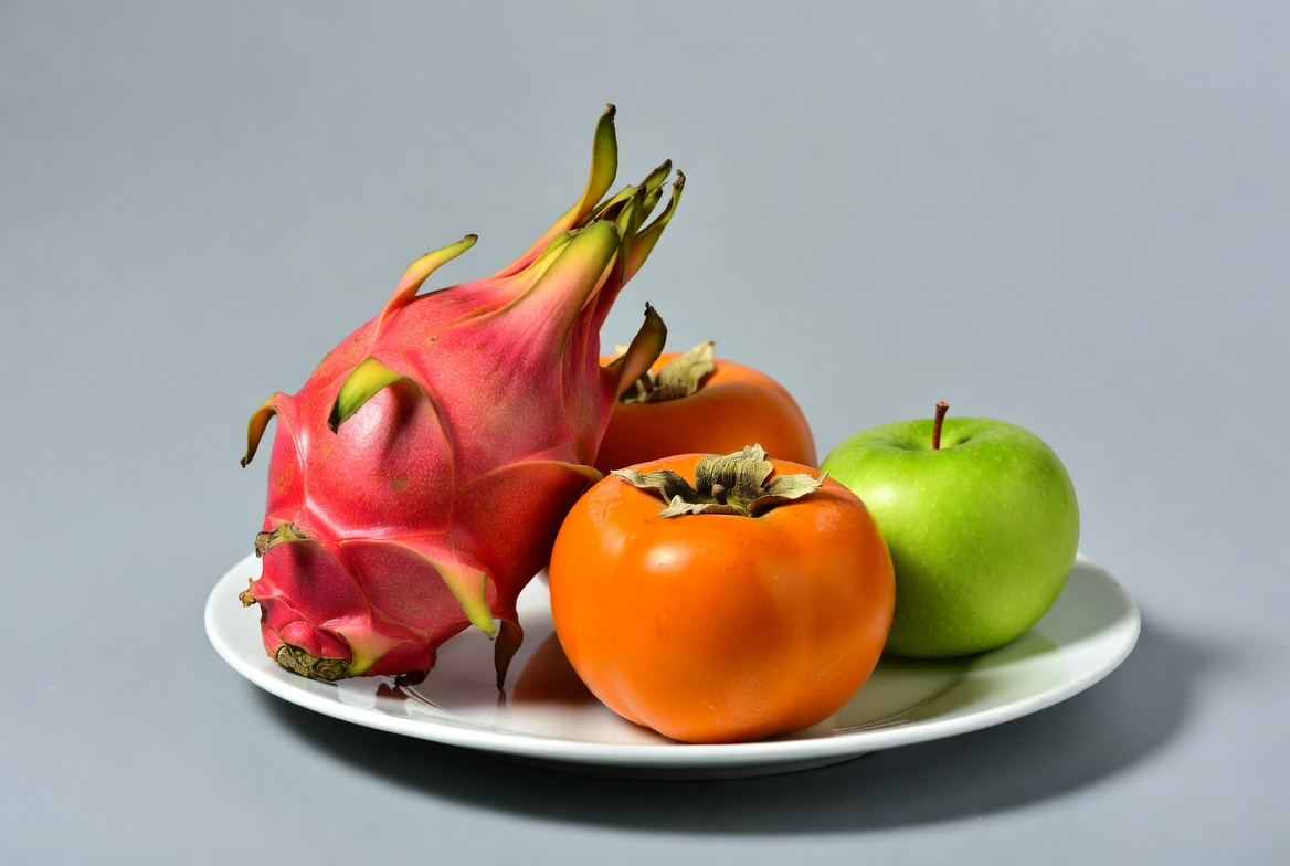 Dragon Fruit Persimmons Apples on Plate Dragon Fruit Persimmons Apples on Plate