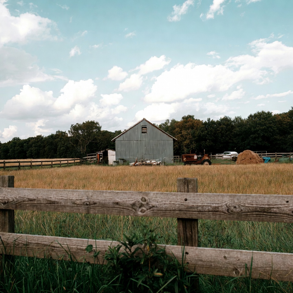 Rustic Barn and Red Tractor in Field Rustic Barn and Red Tractor in Field