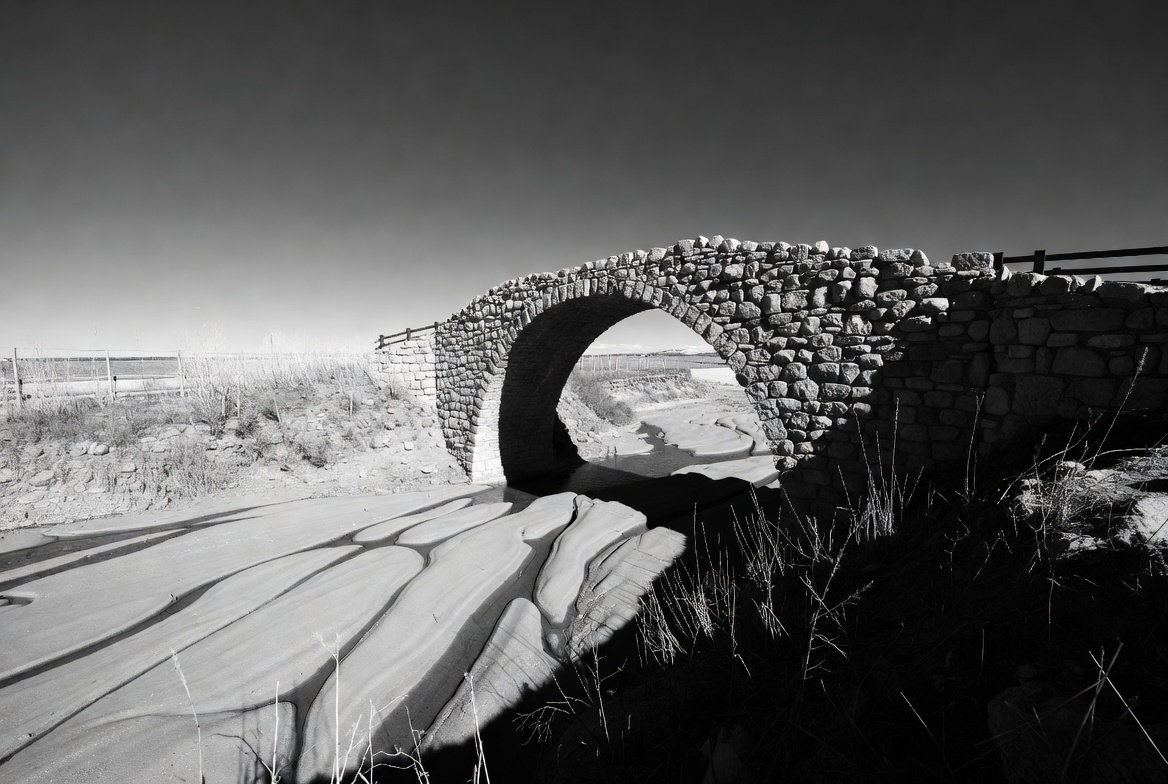 Stone Arch Bridge over Sandy Beach Stone Arch Bridge over Sandy Beach