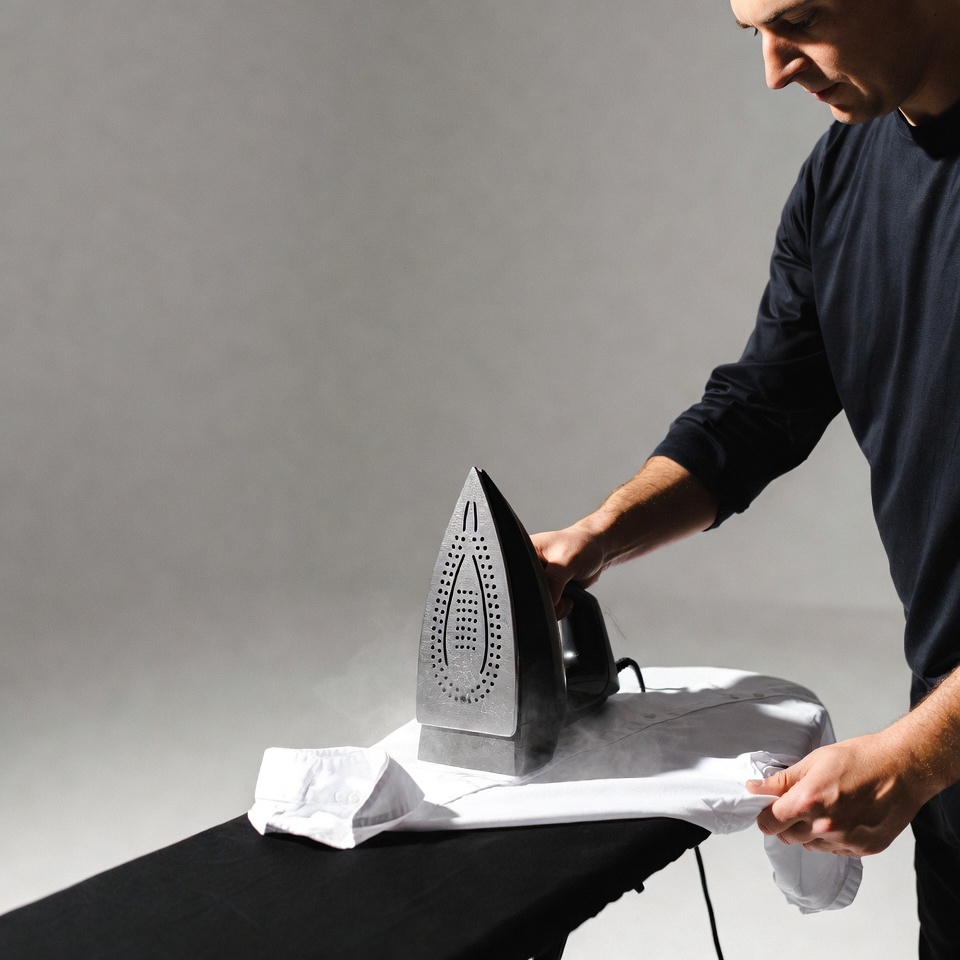 Man ironing white shirt Man ironing white shirt