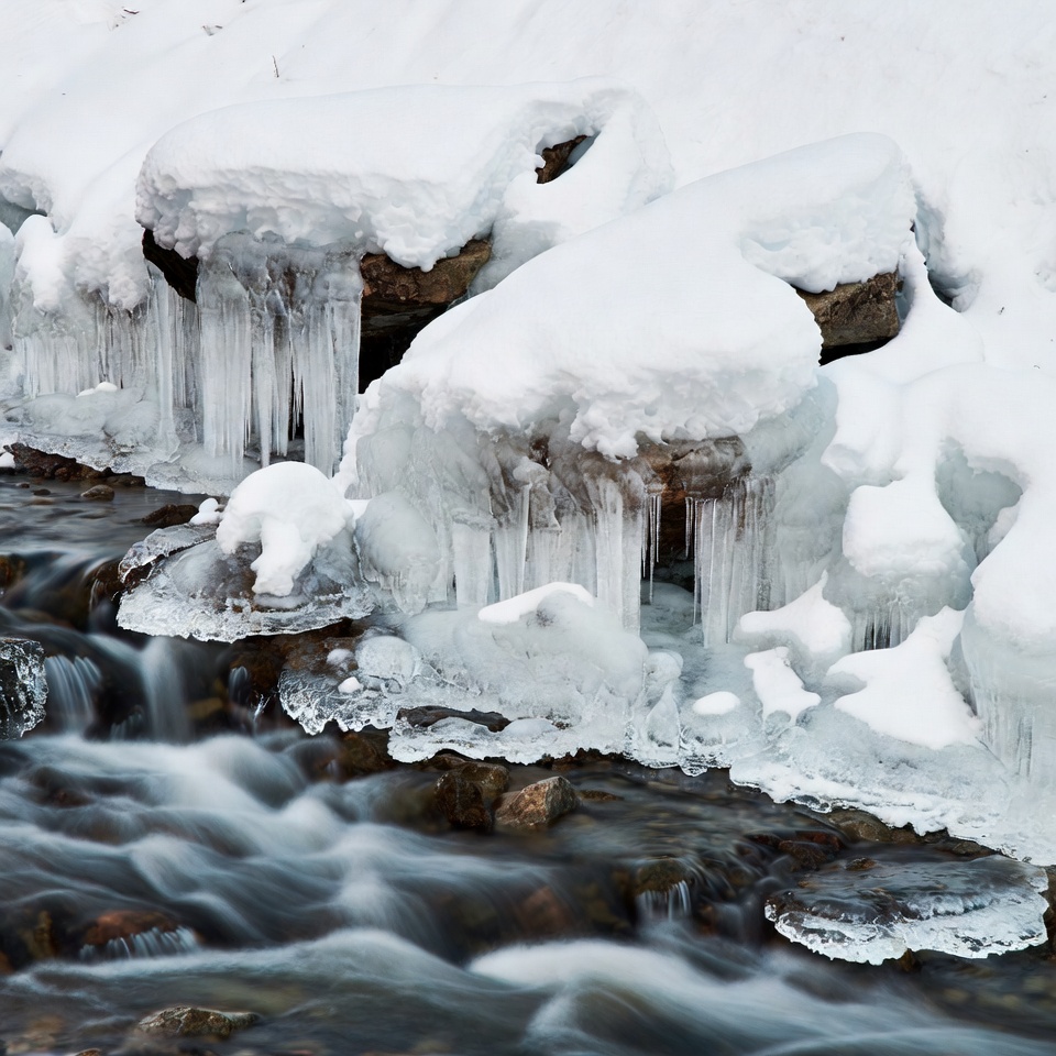 Icy Rocks and Flowing Stream in Snow Icy Rocks and Flowing Stream in Snow