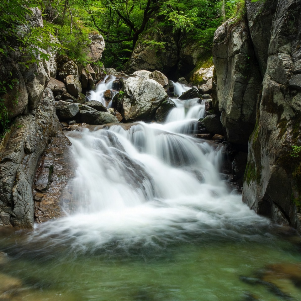 Waterfall cascading rocks green forest Waterfall cascading rocks green forest