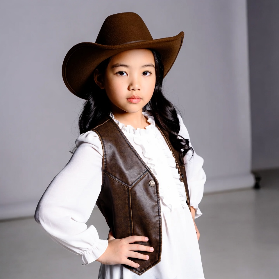 Asian girl in cowboy hat and vest Asian girl in cowboy hat and vest