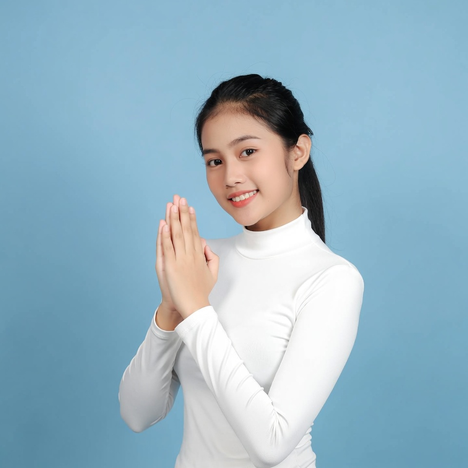 Asian girl praying hands blue background Asian girl praying hands blue background