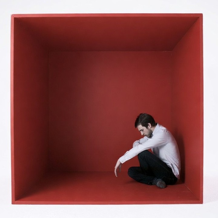 Man sitting in red box Man sitting in red box