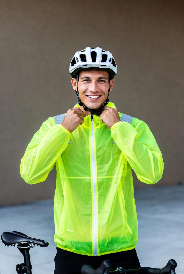 Man adjusting helmet by bike Man adjusting helmet by bike