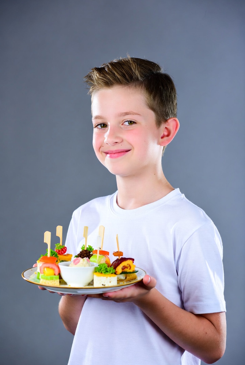 Boy holding plate of appetizers Boy holding plate of appetizers