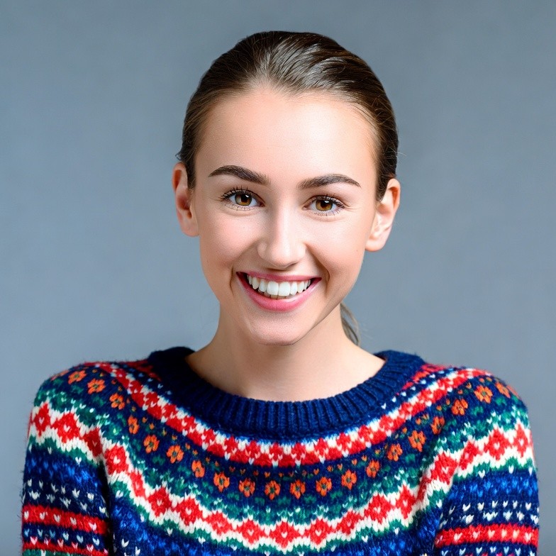 Smiling young woman in colorful sweater Smiling young woman in colorful sweater