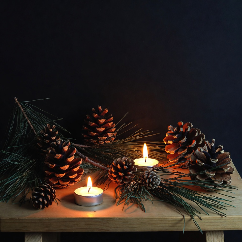 Pine Cones and Candles on Wooden Table Pine Cones and Candles on Wooden Table