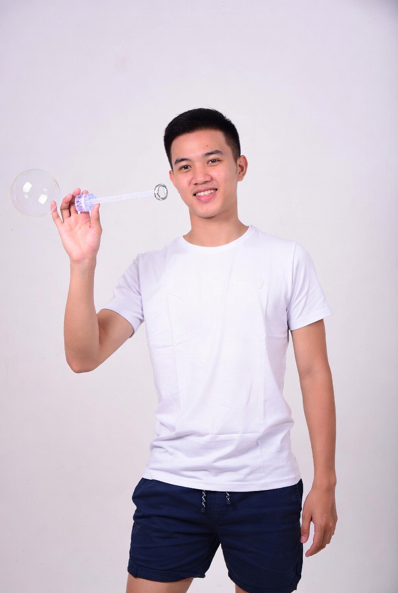 Asian man blowing giant bubble Asian man blowing giant bubble