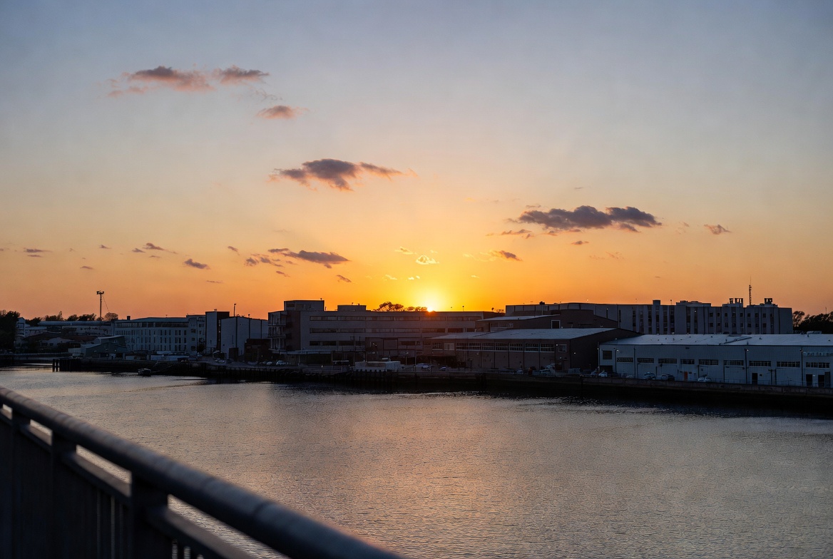 Sunset over river and industrial buildings Sunset over river and industrial buildings