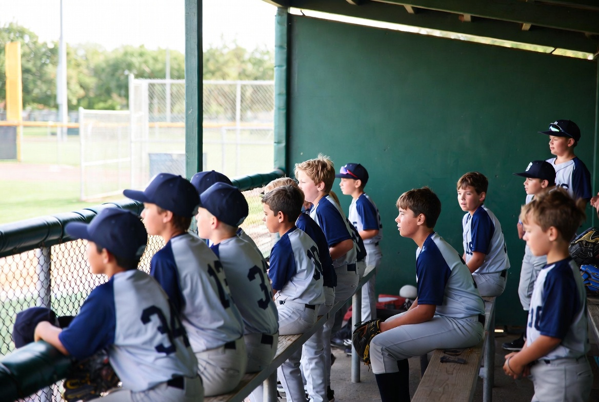 Boys baseball team on dugout bench Boys baseball team on dugout bench