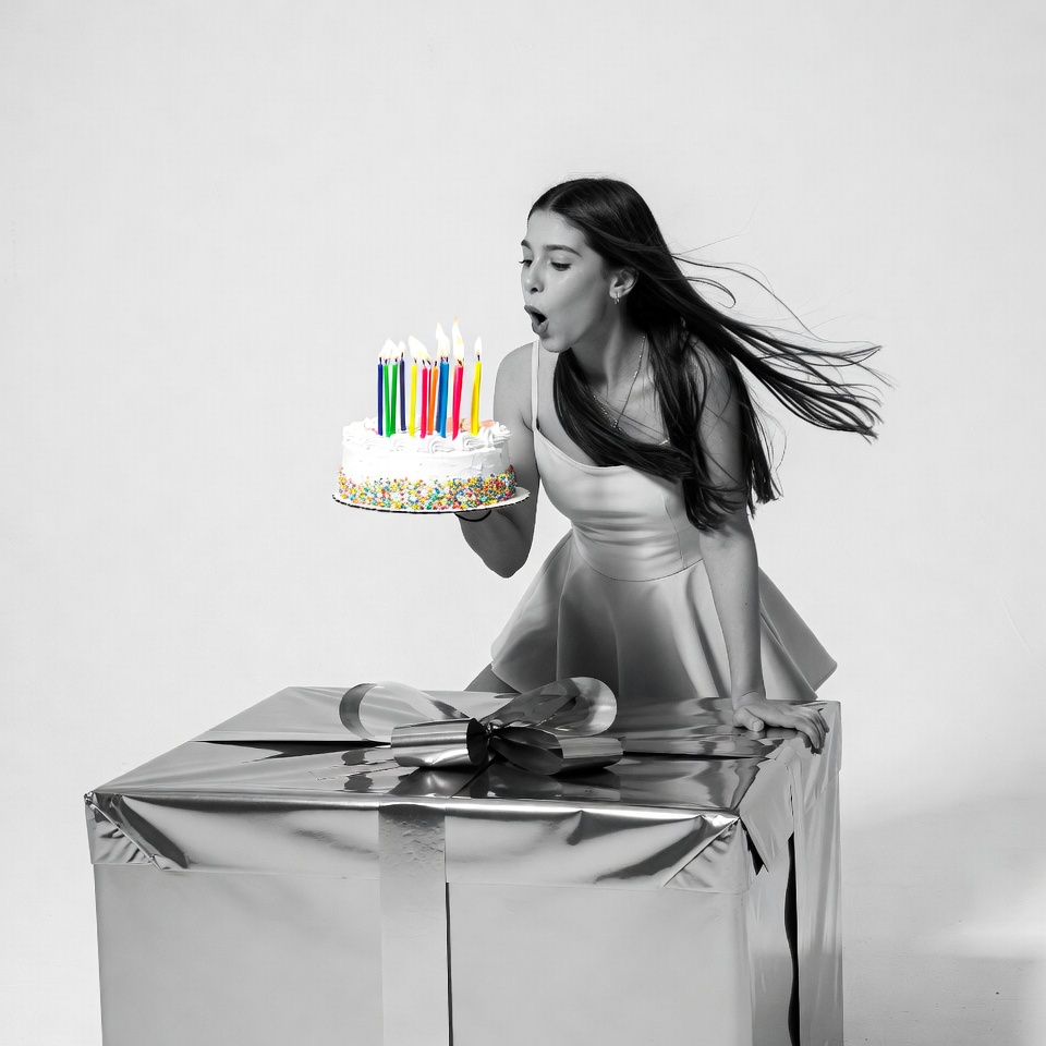 Woman blowing out birthday cake candles Woman blowing out birthday cake candles