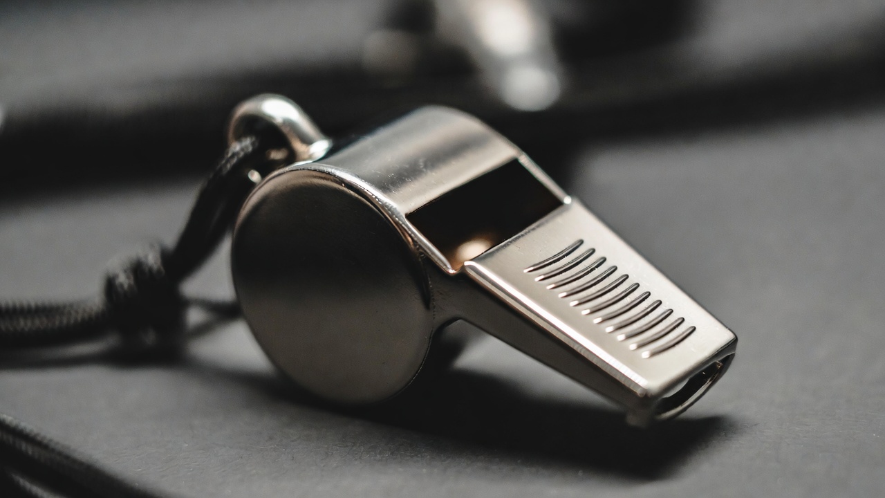 Silver whistle on black cord Silver whistle on black cord