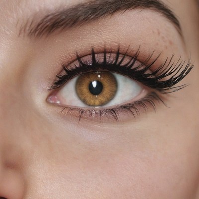 Close-up of a brown eye with long eyelashes