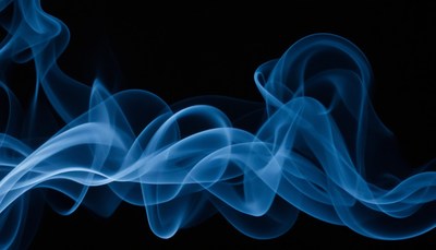 Blue smoke swirls against black background