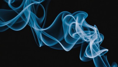 Blue smoke trails against black background