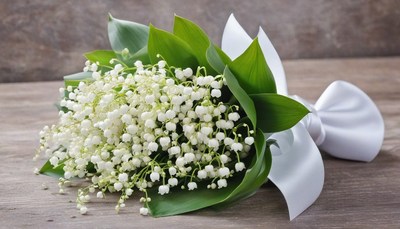 Lily of the valley bouquet on wooden surface