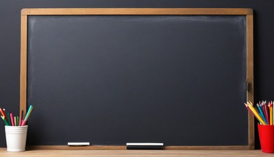 Empty blackboard with chalk and crayons