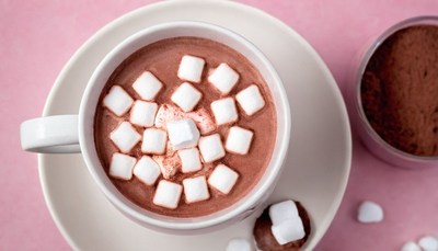 Hot chocolate with marshmallows on pink background
