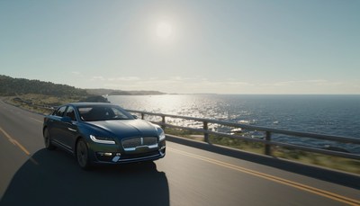 Car driving coastal road at sunset