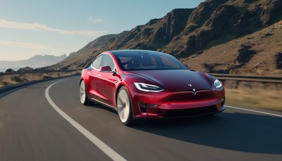 Red tesla driving on coastal road