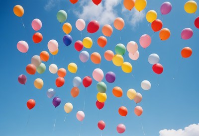 Colorful balloons floating in sky