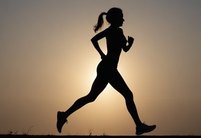 Woman running at sunset
