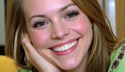 Woman smiling with hand on chin