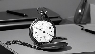 Open pocket watch on desk