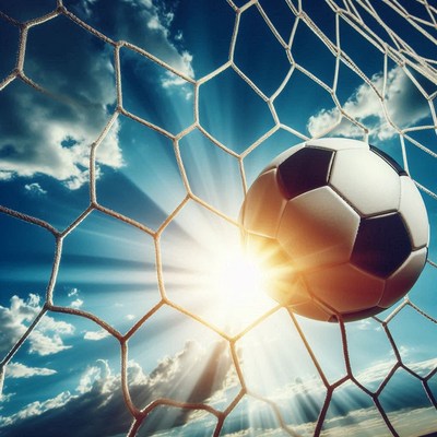 Soccer ball hitting goal net under bright sunlight