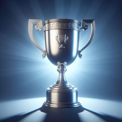 Silver trophy displayed with dramatic lighting