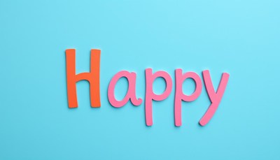 Colorful letters spell happy against blue background