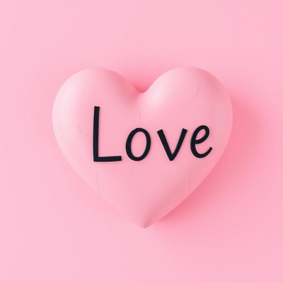 Heart decoration with love on pink background