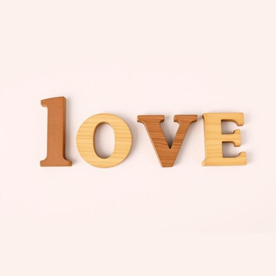 Wooden letters spelling love on light background