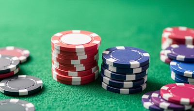 Colorful poker chips stacked on green felt table