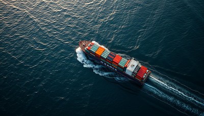 Container ship navigating calm waters at dusk