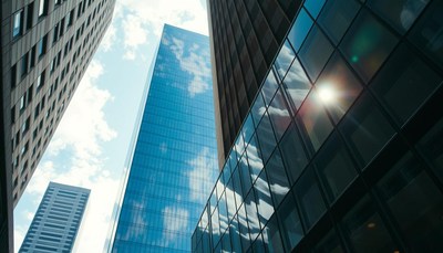 Tall buildings reflect the sky