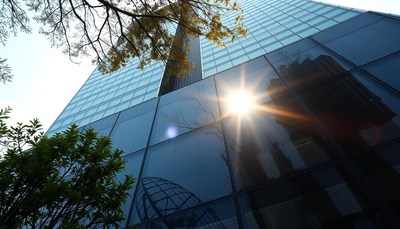 Tall building reflecting sunlight in the city