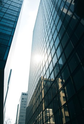Glass skyscraper reflecting sunlight