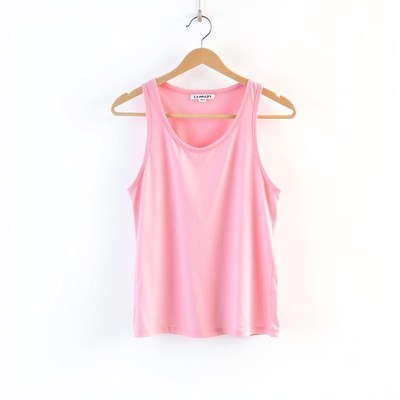 A pink tank top hangs on a hanger