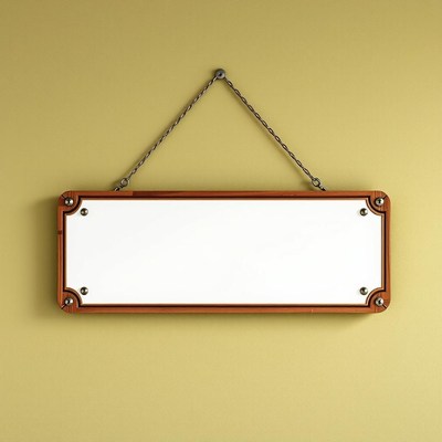 A blank wooden sign hangs on a yellow wall