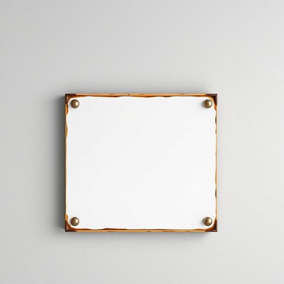 A white sign with a wooden frame hangs on a wall