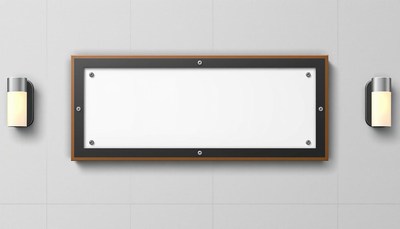 A blank sign hangs on a wall with two lights