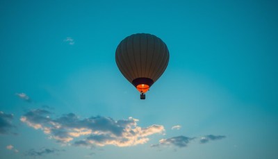 A hot air balloon floats in the blue sky