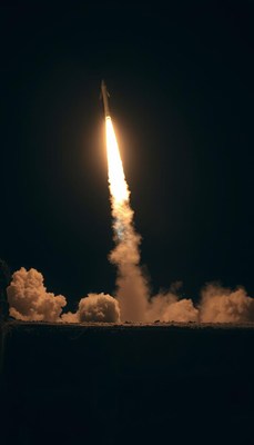 A rocket launches into the night sky