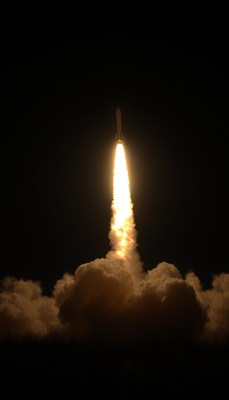 A rocket launches into the night sky