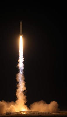 A rocket launches into the night sky