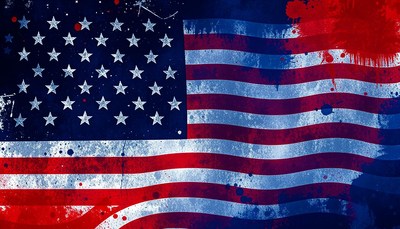 A distressed american flag with red and blue paint splatters